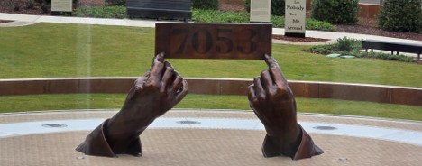 Sculpture by Hank Willis Thomas in Montgomery Square Park taken by Aaron Kinzel. The sculpture shows Rosa Parks' hands holding up her jail number